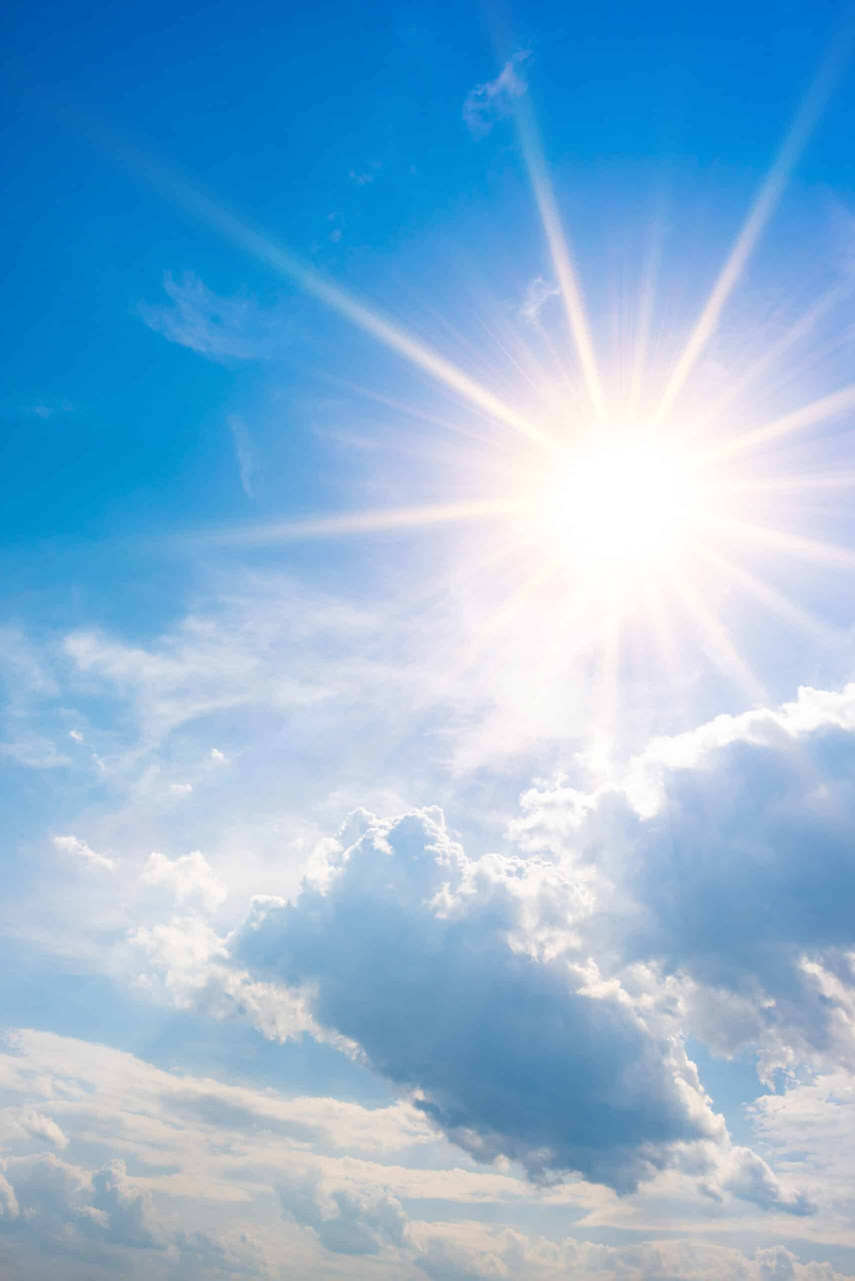 Blue sky with bright sun and clouds