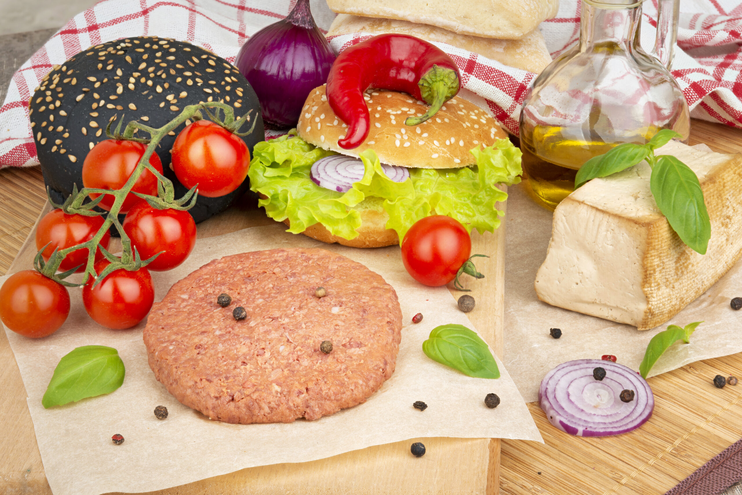 Cooking ingredients for vegan burgers on a table, vegetables, tofu, oil