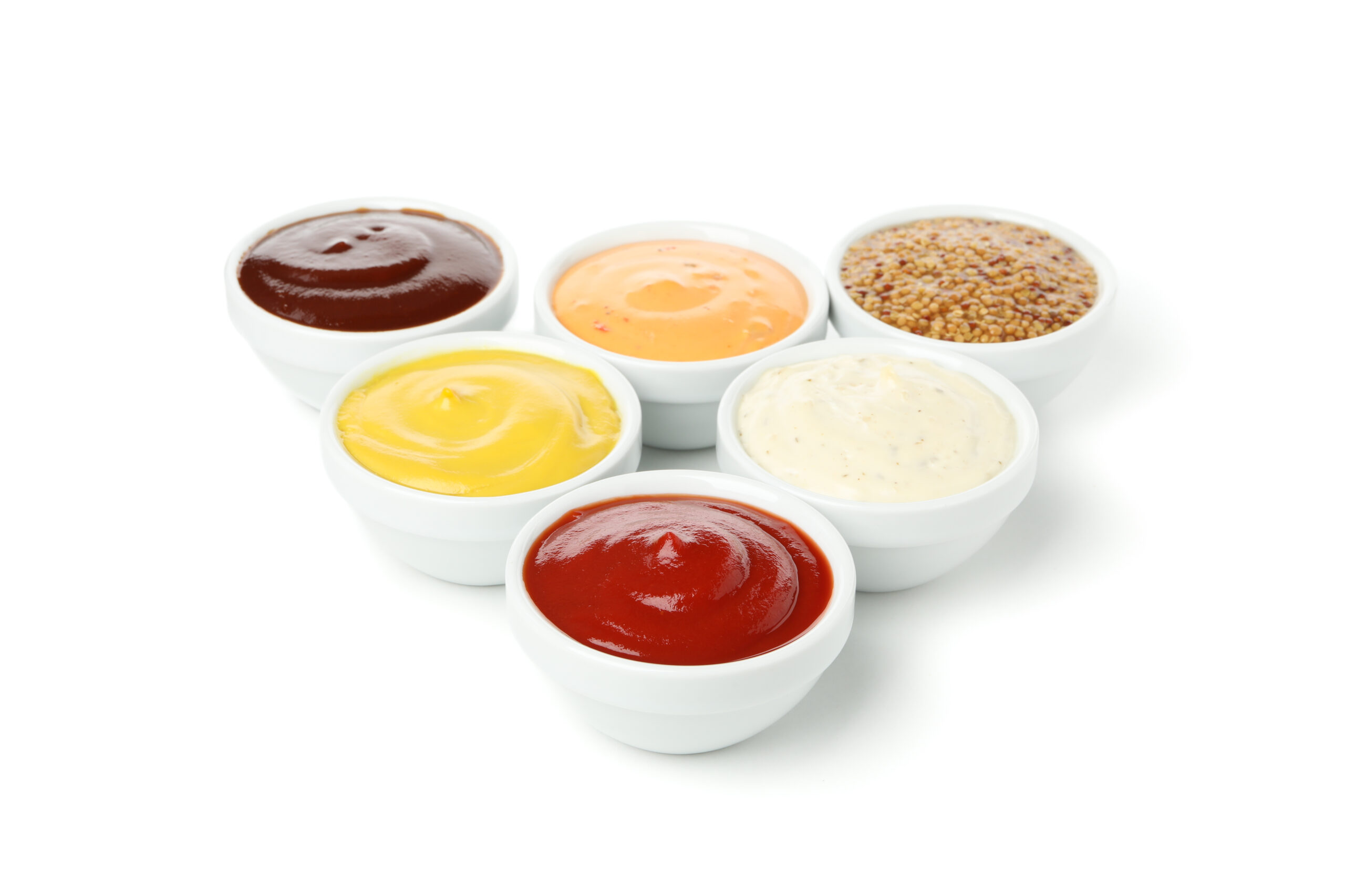 Tasty sauces in bowls isolated on white background