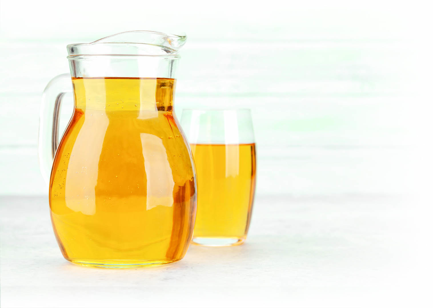 Apple juice in jug and glass. With copy space